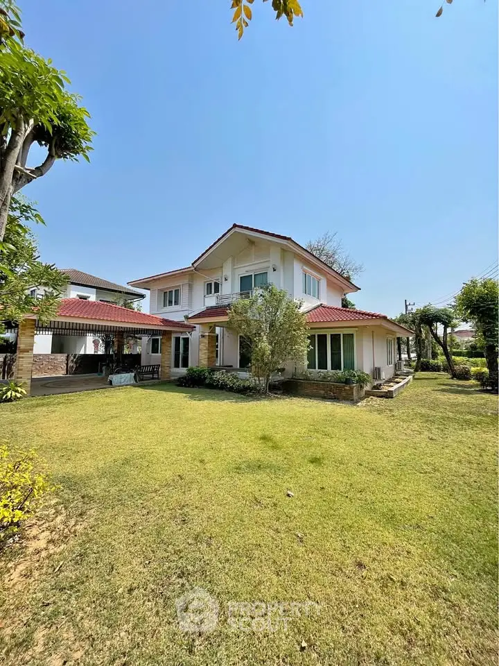 Charming two-story house with spacious garden and lush greenery, perfect for family living.