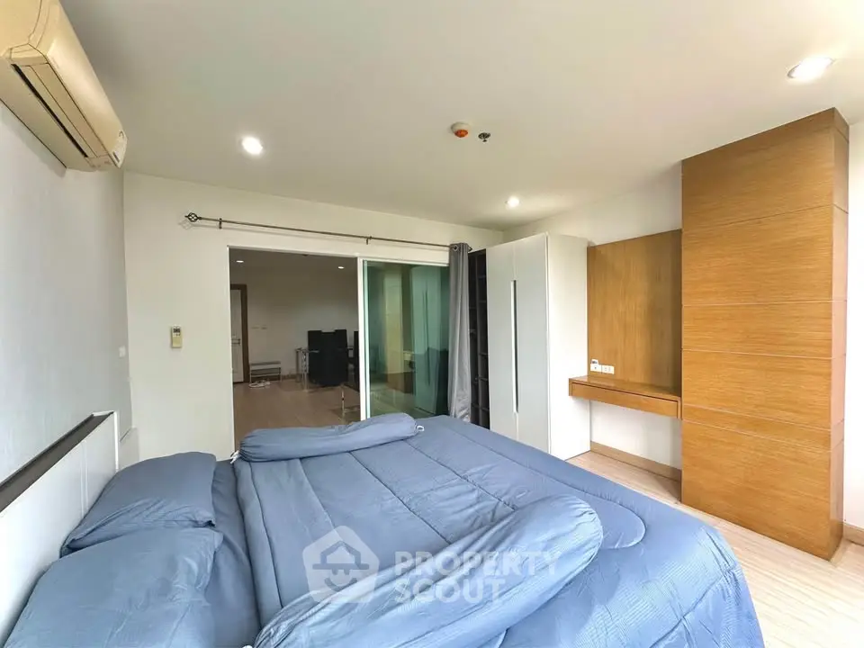 Spacious bedroom with modern decor and ample natural light