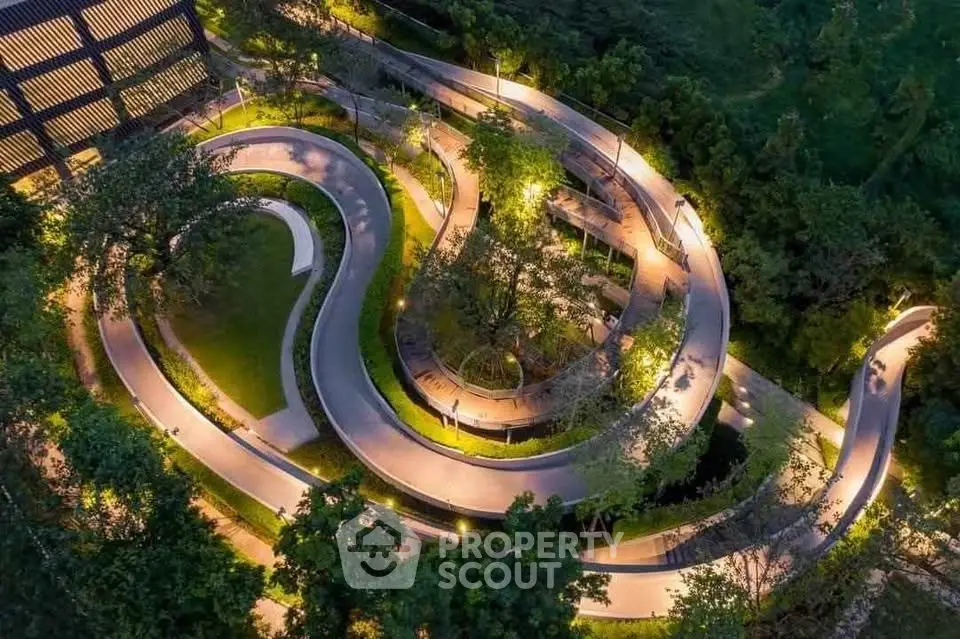 Stunning aerial view of illuminated winding pathways in a lush garden setting, perfect for evening strolls.