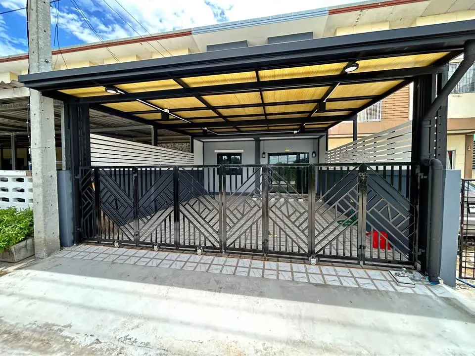 Modern house exterior with stylish metal gate and covered carport