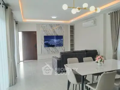 Modern living room with elegant decor, marble accents, and stylish furniture in a contemporary home.