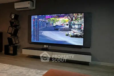 Modern living room with large TV and stylish shelving unit