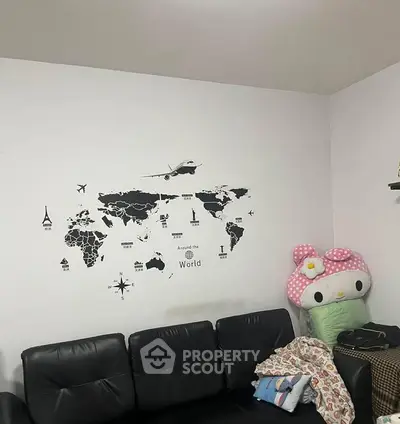 Cozy living room with world map wall art and plush seating, perfect for relaxation and travel inspiration.