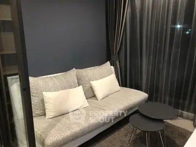 Modern living room with cozy sofa and stylish curtains