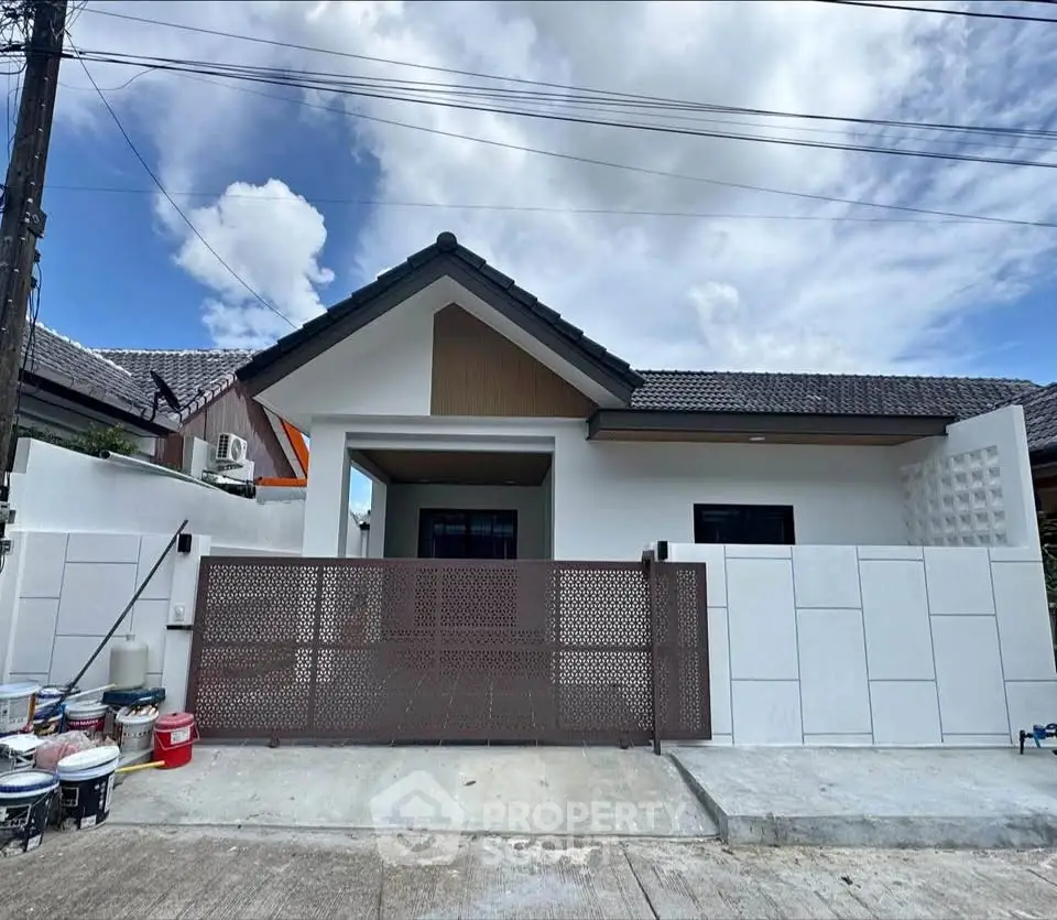 Charming single-story home with modern facade and gated entrance in a serene neighborhood.