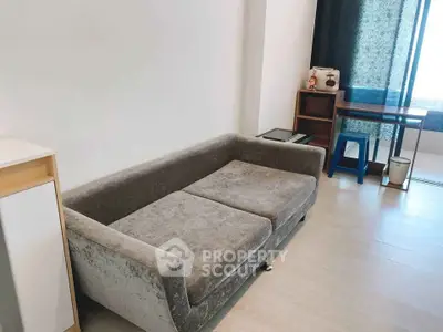 Modern living room with plush gray sofa and stylish decor