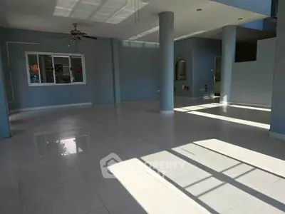 Spacious open-plan living area with modern design and ample natural light.