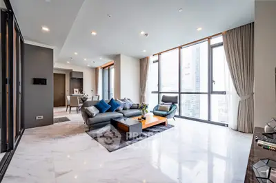 Luxurious modern living room with marble floors and large windows offering city views.