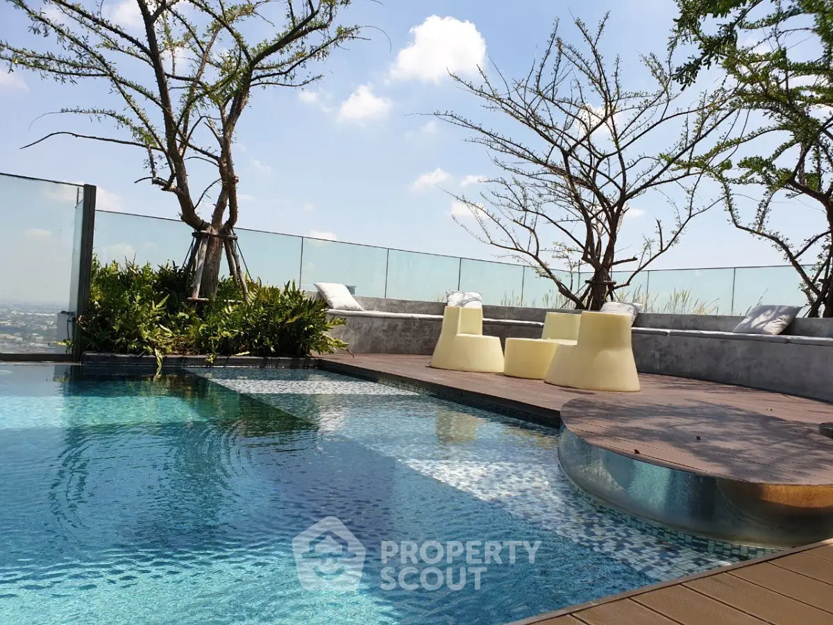 Luxurious rooftop pool with stunning city views and modern seating area.