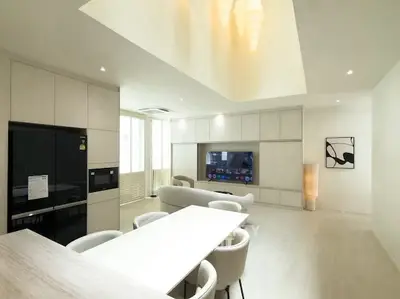 Modern open-plan living room with sleek furniture and built-in entertainment center