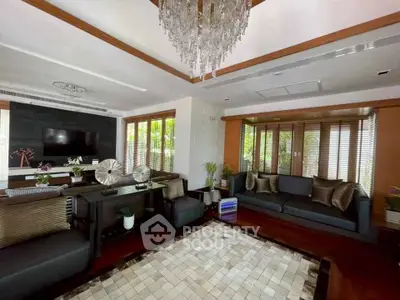 Luxurious living room with elegant decor and large windows offering natural light.