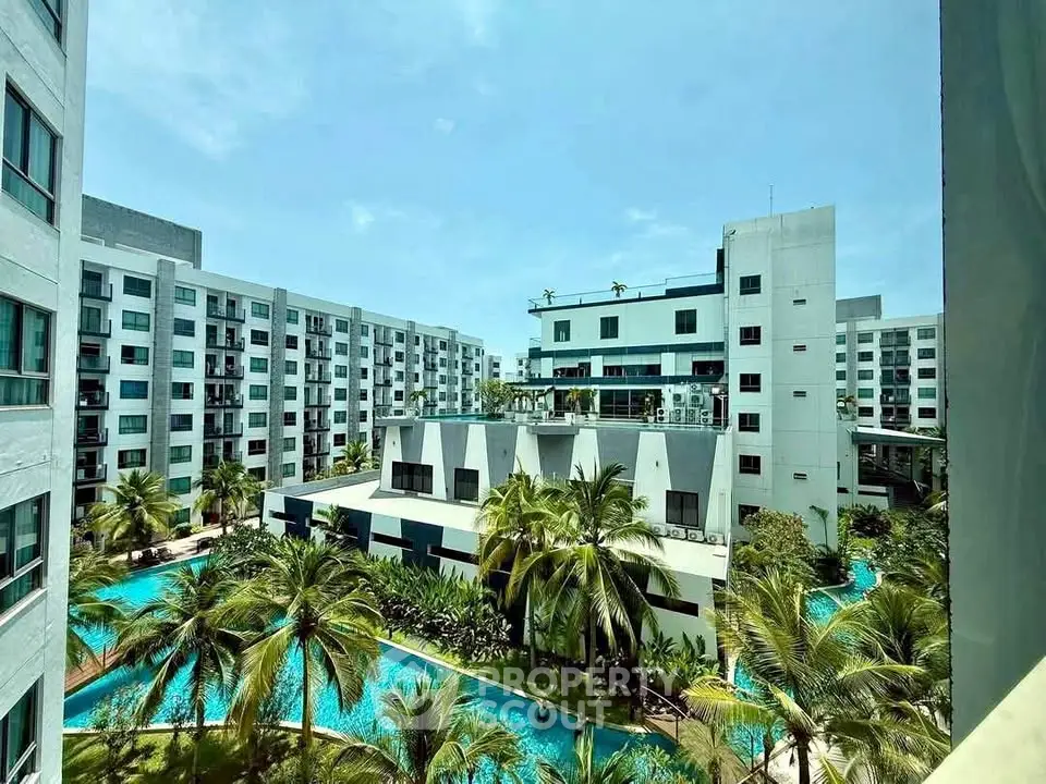 Luxurious apartment complex with stunning pool and lush greenery