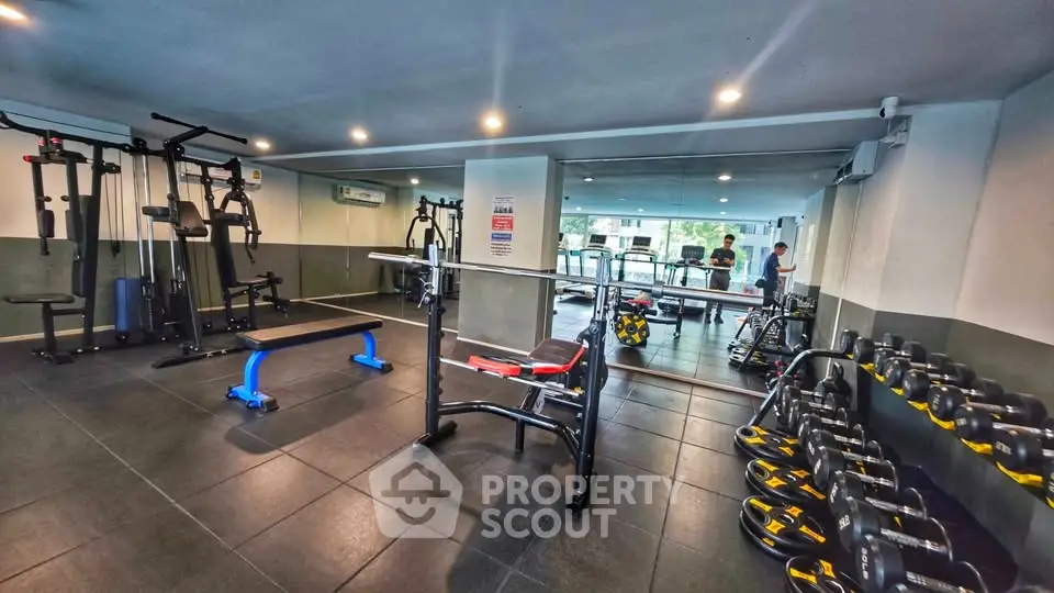 Modern gym with state-of-the-art equipment in a residential building, perfect for fitness enthusiasts.