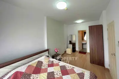 Spacious bedroom with modern decor and ensuite bathroom in a stylish apartment.