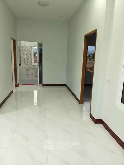 Spacious modern interior with glossy tile flooring and open doorways