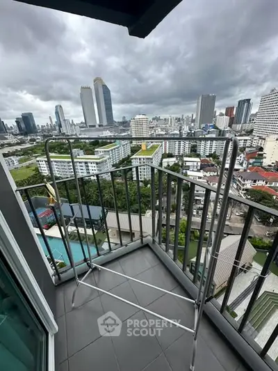 Stunning cityscape view from a high-rise balcony with modern railing and expansive skyline.