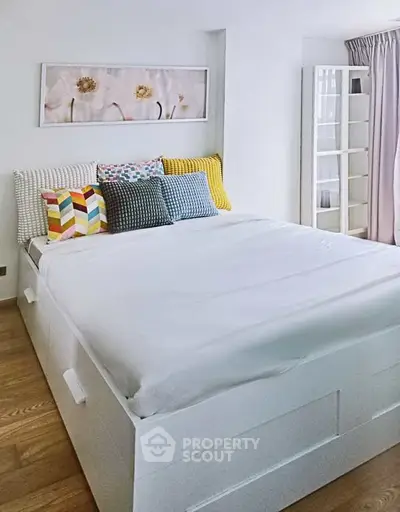 Cozy bedroom with stylish decor and ample natural light