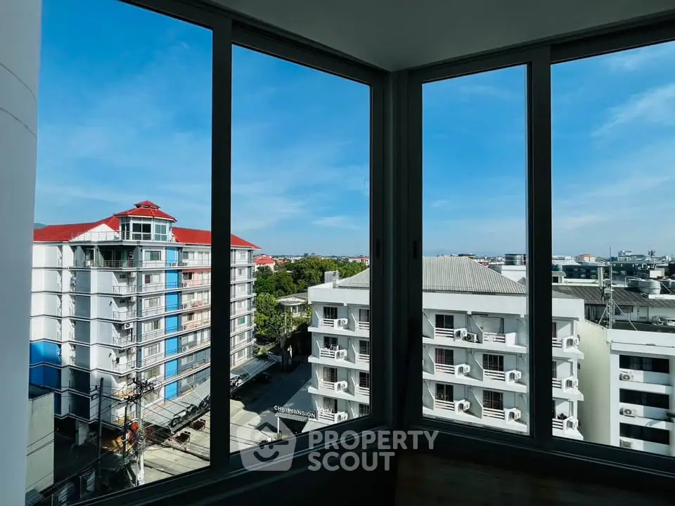 Stunning cityscape view from a modern apartment window, showcasing urban living at its finest.