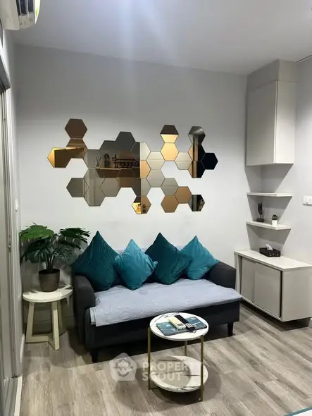 Modern living room with stylish hexagonal wall decor and cozy seating area.
