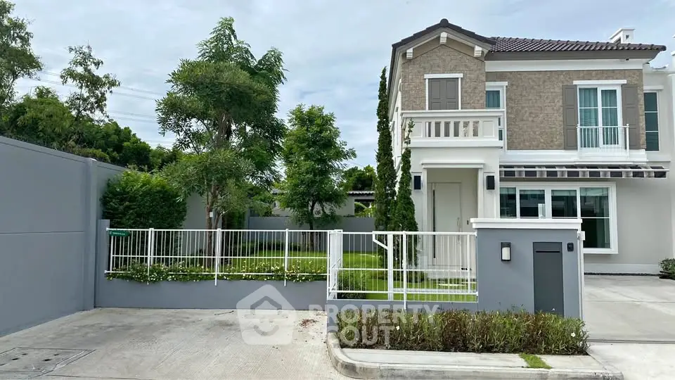 Charming two-story house with lush garden and modern exterior design in a serene neighborhood.