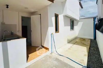 Charming exterior view of a modern home with clean lines and a small outdoor area.