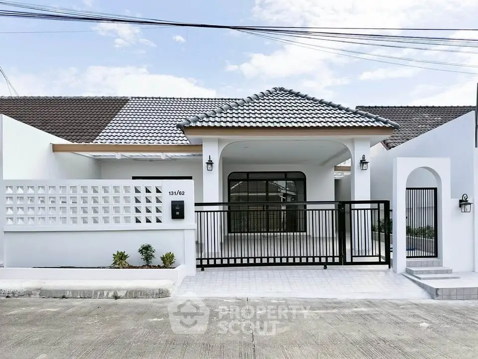 Charming modern bungalow with tiled roof and gated entrance, perfect for family living.