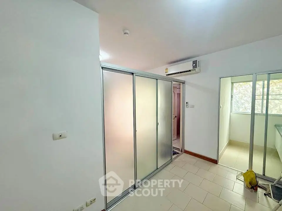 Spacious room with sliding glass doors and air conditioning unit, ideal for modern living.