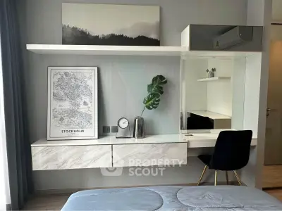 Modern bedroom with stylish decor and workspace in a contemporary apartment.