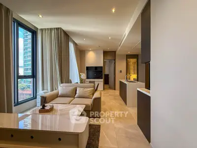 Luxurious modern living room with open kitchen and large windows offering city views.