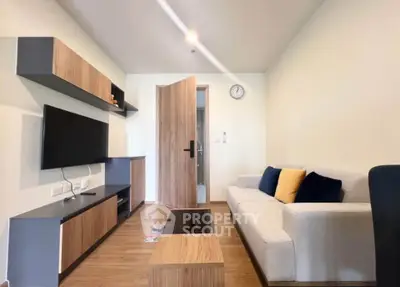 Modern living room with sleek furniture and wall-mounted TV, perfect for cozy relaxation.