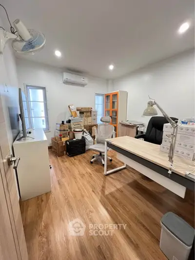 Modern study room with wooden flooring and ample storage space, ideal for productivity and organization.