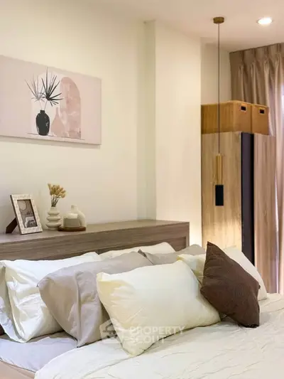 Cozy bedroom with stylish decor and soft lighting, featuring a comfortable bed and elegant wall art.
