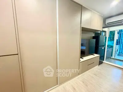 Modern apartment interior with sleek storage and balcony view