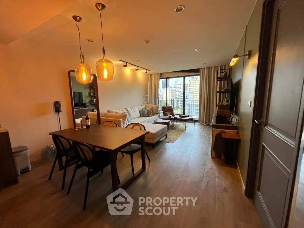 Spacious modern living room with elegant dining area and city view, perfect for urban living.