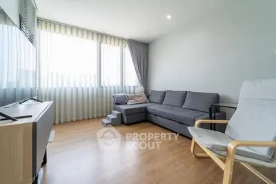 Spacious living room with modern furniture and large windows for natural light.