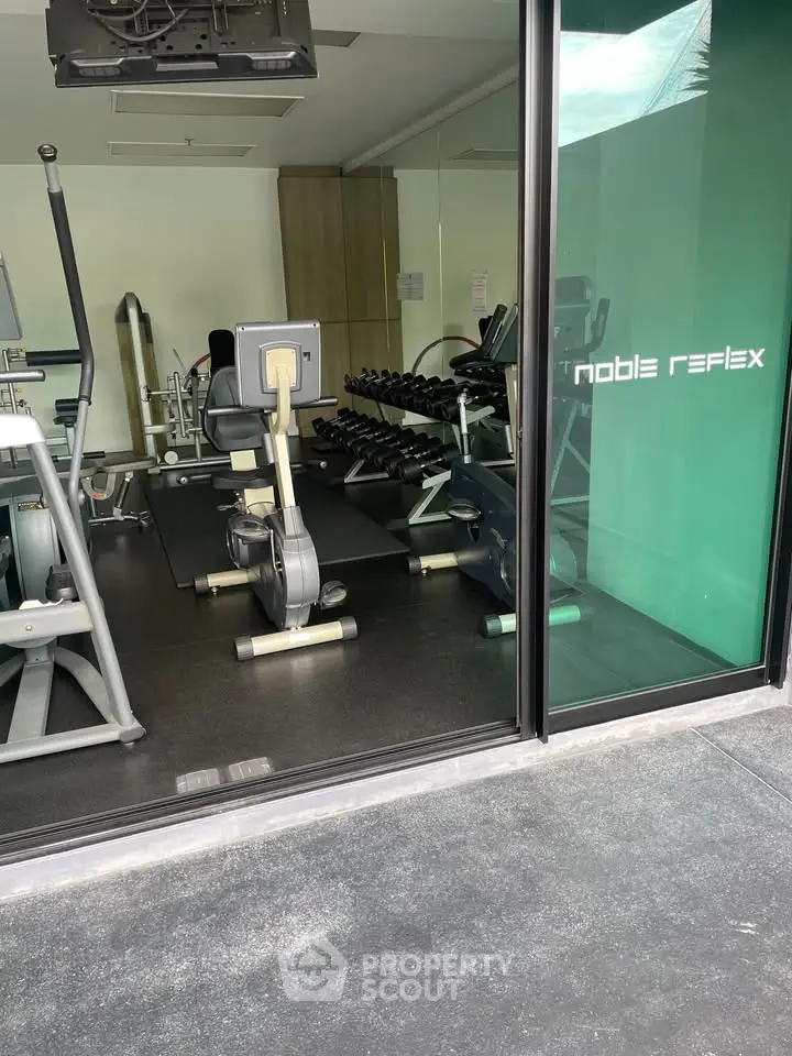 Modern gym with state-of-the-art fitness equipment in a luxury residential building.
