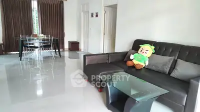 Spacious living room with modern furniture and dining area, perfect for family gatherings.