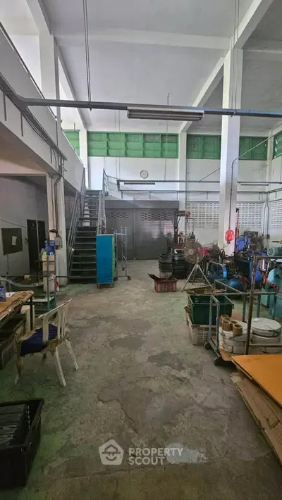 Spacious industrial workspace with high ceilings and natural light