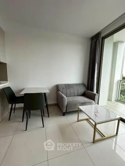 Modern living room with sleek furniture and balcony access in a stylish apartment.