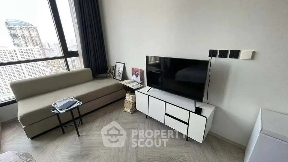 Modern living room with city view, sleek furniture, and stylish decor in a high-rise apartment.