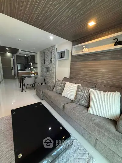 Modern living room with stylish decor and open kitchen layout in a contemporary apartment.