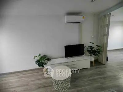 Modern living room with sleek TV setup and air conditioning