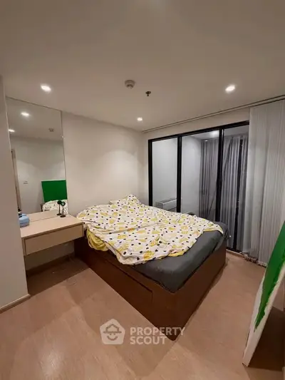 Cozy bedroom with modern decor and large window for natural light
