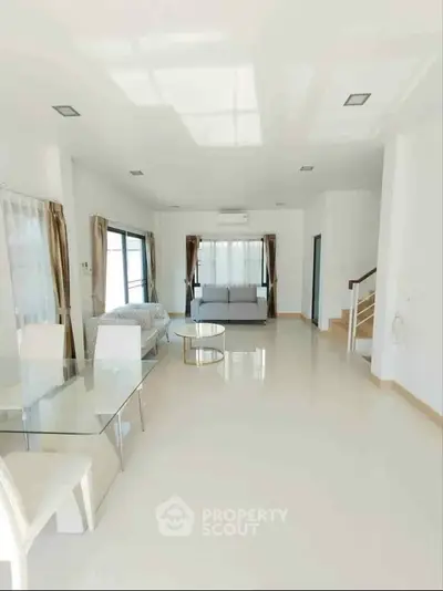 Spacious modern living room with elegant decor and ample natural light