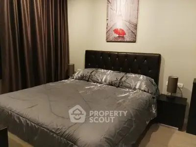 Cozy bedroom with elegant decor and plush bedding in modern apartment.