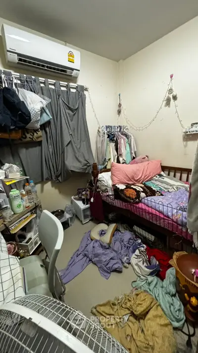 Cozy bedroom with air conditioning and ample storage space, ideal for urban living.