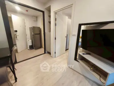 Modern apartment interior with open layout, featuring a sleek kitchen and cozy living area.