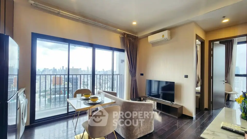 Modern living room with city view, featuring elegant furniture and open layout.