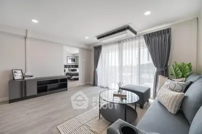 Spacious modern living room with stylish decor and natural light