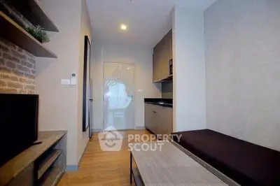 Modern living room with sleek design and open kitchen layout in a stylish apartment.